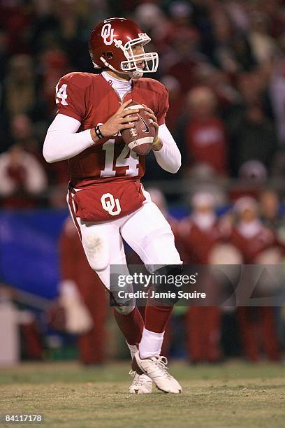 Quarterback Sam Bradford of the Oklahoma Sooners drops back to pass the ball during the Big 12 Championship game against the Missouri Tigers on...