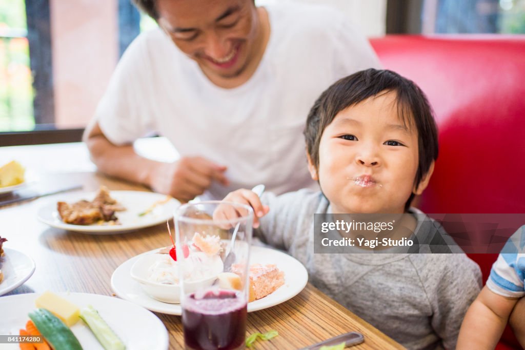 Family enjoying take a buffet style meal at Resort Hotel in guam