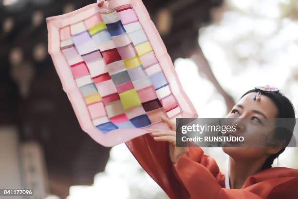traditional korean woman holding korean traditional cloth - korean culture stock pictures, royalty-free photos & images