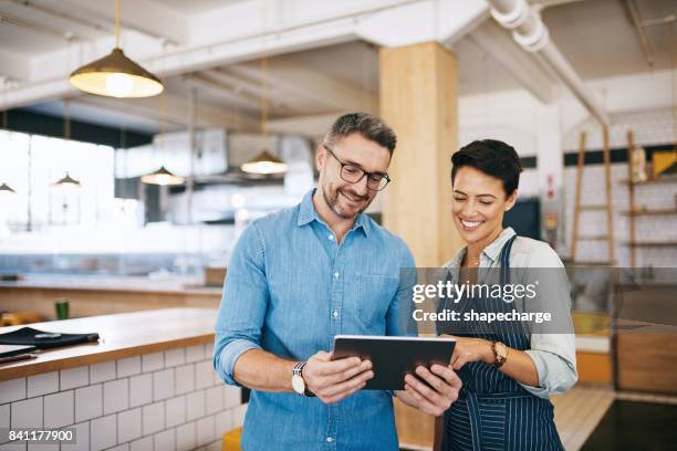 running a coffee shop using a smart management system - business owner stock pictures, royalty-free photos & images