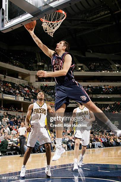 Ryan Anderson of the New Jersey Nets lays the ball up over Jarrett Jack of the Indiana Pacers at Conseco Fieldhouse December 23, 2008 in...
