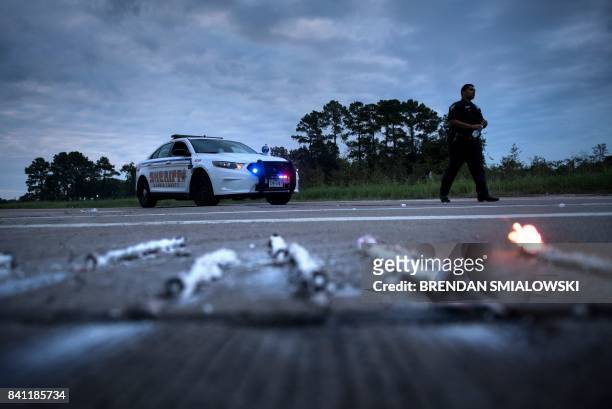 Sheriff walks near a roadblock after a chemical plant operated by the Arkema Group had an explosion during the aftermath of Hurricane Harvey August...