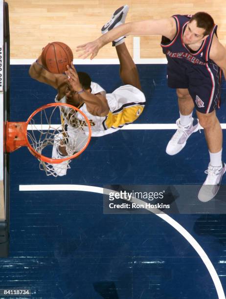 Brandon Rush of the Indiana Pacers lays the ball up on Ryan Anderson of the New Jersey Nets at Conseco Fieldhouse December 23, 2008 in Indianapolis,...