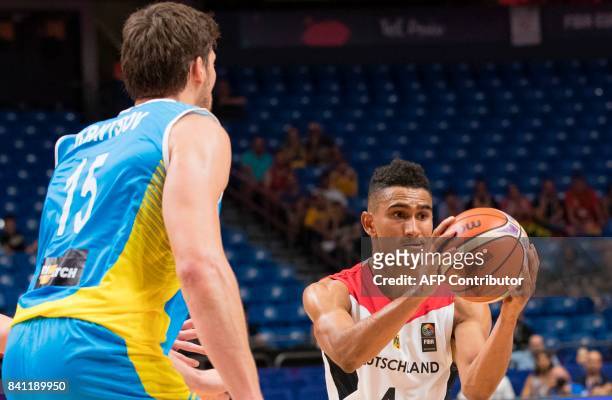 Germany's point guard Maodo Lo looks to pass as he is marked by Ukraine's center Viacheslav Kravtsov during the FIBA EuroBasket 2017 basketball...