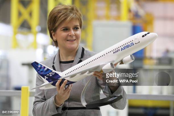 Scottish First Minister Nicola Sturgeon holds a model of an Airbus 320 after making a keynote speech on Scotland economy at Spirit Aerospace in...