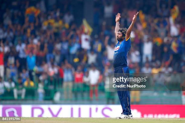 Sri Lankan cricket captain Lasith Malinga celebrates after completing 300 wickets in his One Day International career during the 4th One Day...