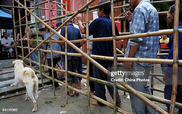 Election committee members set up the voting site to keep order prior to the triennial village election at the Jiuxian Village on June 21, 2008 in...