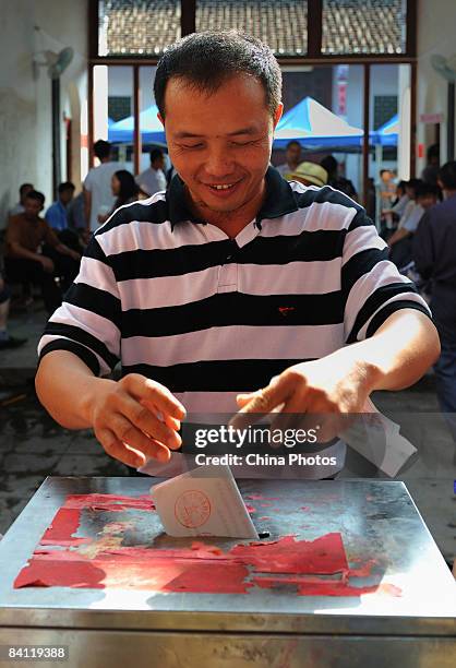 Candidate for the deputy director of the village committee casts his vote during a second round of the triennial village election at the Jiuxian...