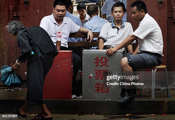 Senior citizen leaves after casting a vote during the triennial village election at the Jiuxian Village on June 24, 2008 in Zhanjiang of Guangdong...