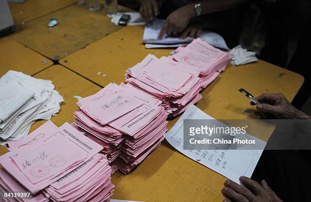 Staff members count ballots at the counting site during the triennial village election at the Jiuxian Village on June 24, 2008 in Zhanjiang of...