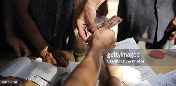 Every villager receives an allowance of three yuan for loss of labor hours during the triennial village election at the Jiuxian Village on June 24,...