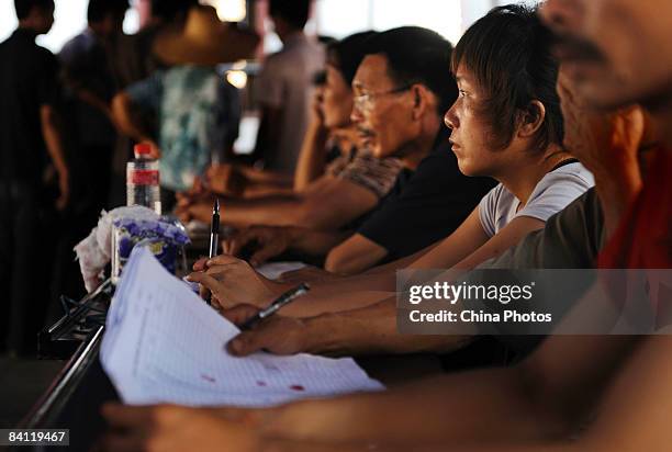 Election committee members wait for voters to cast their ballots during the triennial village election at the Jiuxian Village on June 21, 2008 in...