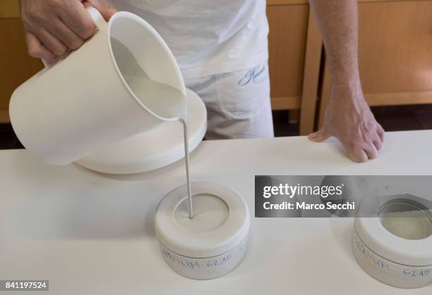 Mihaly Hoffman a staff member at Herand pours the liquid paste into a cast on August 31, 2017 in Veszprem, Hungary. Herend Porcelain founded in 1826...