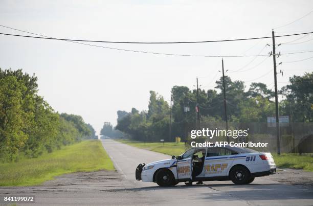 Harris County Sheriff vehicle blocks access on the Crosby Dayton Road which leads towards the Arkema Chemical Plant in Crosby, Texas on August 31,...