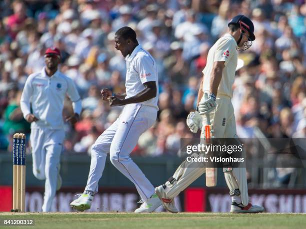 Jason Holder of West Indies celebrates taking the wicket of Alastair Cook of England during the third day of the second test between England and West...