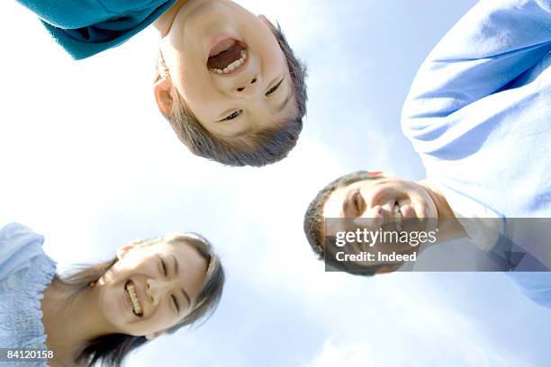 japanese parents and boy smiling, direlctly below - 3 men looking up stock pictures, royalty-free photos & images