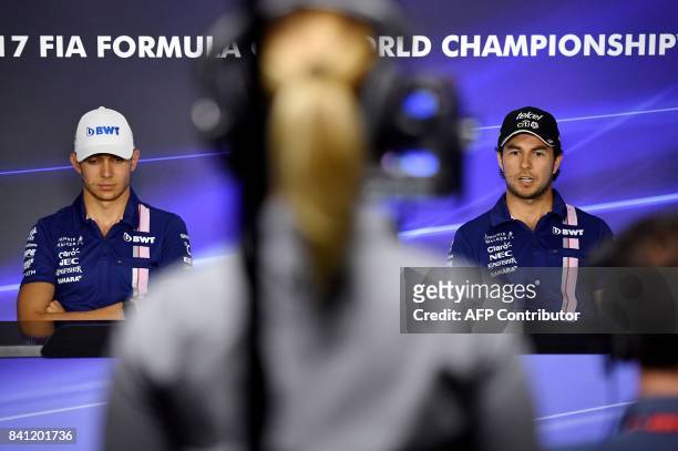 Force India's French driver Esteban Ocon and Force India's Mexican driver Sergio Perez give a press conference at the Autodromo Nazionale circuit in...
