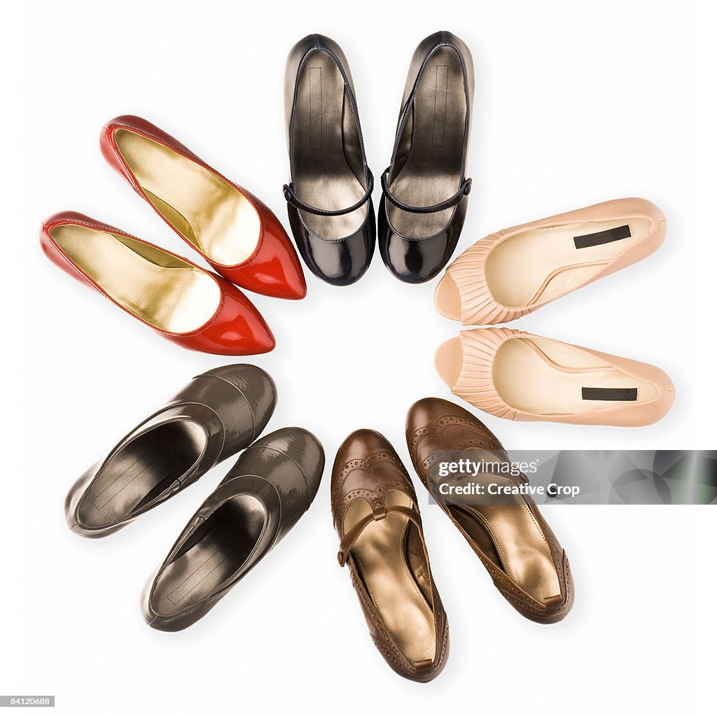 Circle of five pairs of woman's shoes