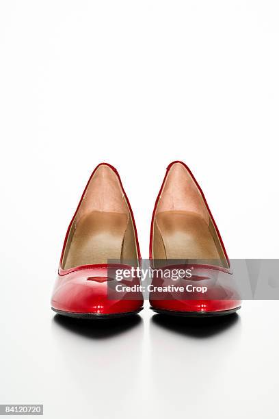 a pair of red high heels facing the camera - high heels on white stock pictures, royalty-free photos & images