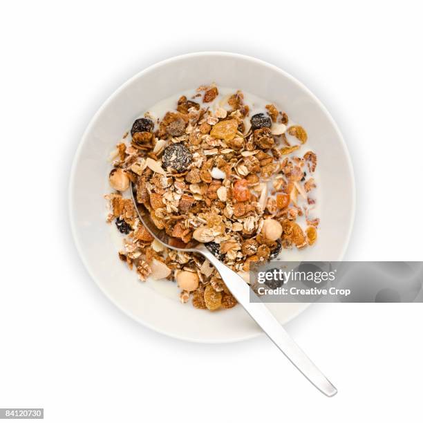 overhead view of bowl of muesli with milk - dried food stock pictures, royalty-free photos & images