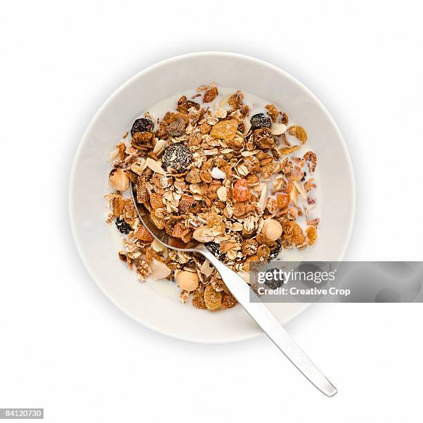 overhead view of bowl of muesli with milk - cereais de pequeno almoço imagens e fotografias de stock