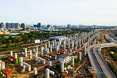 The infrastructure of sky train railway in the middle of Bangkok city. The pillars of foundation are posted in pattern line, coming out from the new main station