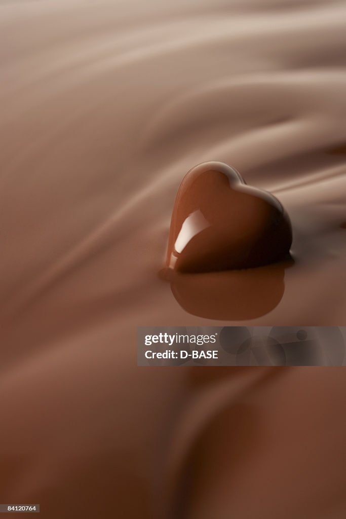 Melted heart shaped chocolate in melted chocolate