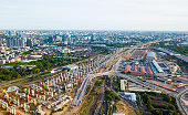 The super high aerial view of sky train railway and station construction. This will be the main train station of Bangkok in the future. The pillars of foundation line in pattern heading out of town