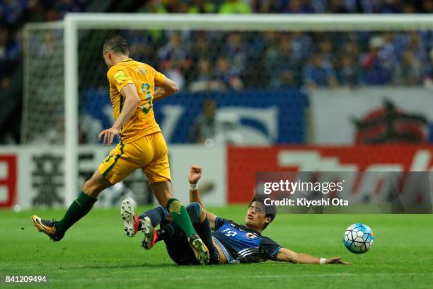 Brad Smith of Australia is tackled by Hiroki Sakai of Japan during the FIFA World Cup Qualifier match between Japan and Australia at Saitama Stadium...