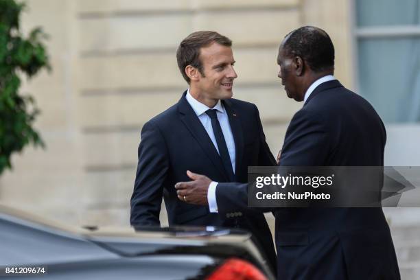 French President Emmanuel Macron welcomes Ivory Coast president Alassane Ouattara prior to a meeting at the Elysee Presidential Palace on August 31,...