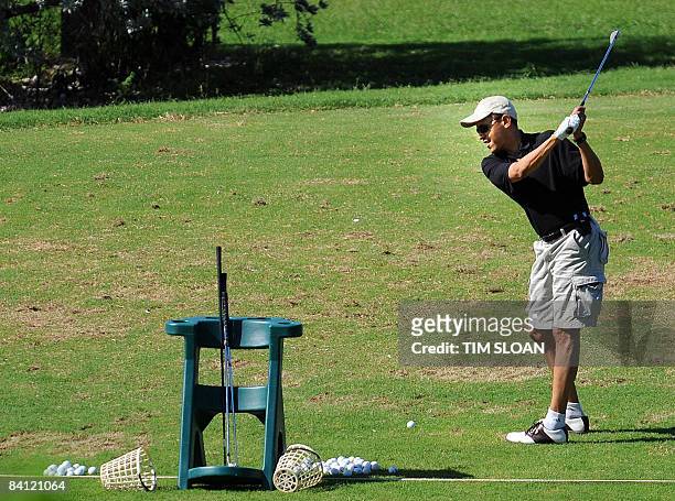 President-elect Barack Obama warms up on the driving range before a Christmas eve round of golf with friends on December 24, 2008 at the Mid Pacific...