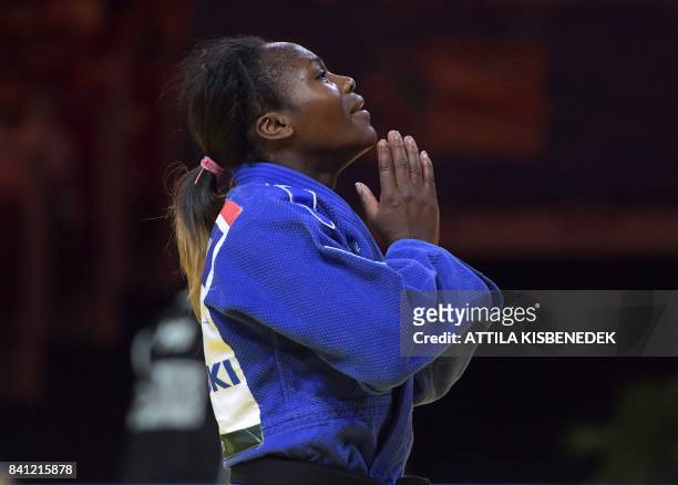 Gold medalist France's Clarisse Agbegnenou celebrates her victory against Slovenia's Tina Trstenjak during their final match in the womens -63kg...