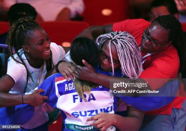 Gold medalist France's Clarisse Agbegnenou celebrates her victory against Slovenia's Tina Trstenjak after their final match in the womens -63kg...