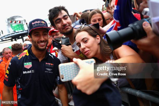 Daniel Ricciardo of Australia and Red Bull Racing poses for a selfie with a fan during previews for the Formula One Grand Prix of Italy at Autodromo...