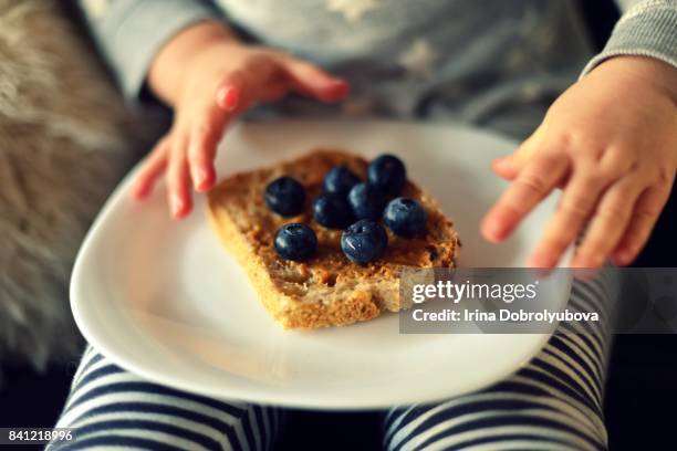 child eating sourdough toast with blueberries - peanut butter toast stock pictures, royalty-free photos & images
