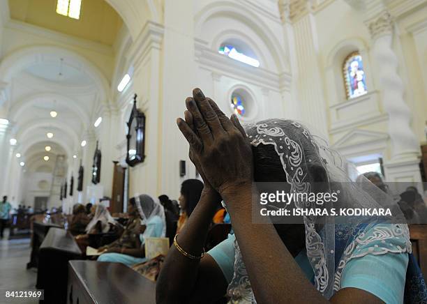 Sri Lankan Christians offer prayers during Christmas mass at the St.Lucia Cathedral in Colombo on December 25, 2008. Sri Lankan Christians make up a...