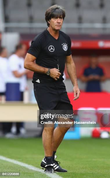 Head coach Joachim Loew walks over the pitch during a Germany training session at Eden Arena ahead of their FIFA World Cup Russia 2018 Group C...