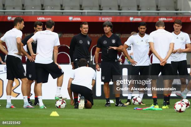 Head coach Joachim Loew talks to the players during a Germany training session at Eden Arena ahead of their FIFA World Cup Russia 2018 Group C...