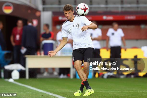 Thomas Mueller passes the ball during a Germany training session at Eden Arena ahead of their FIFA World Cup Russia 2018 Group C Qualifier against...