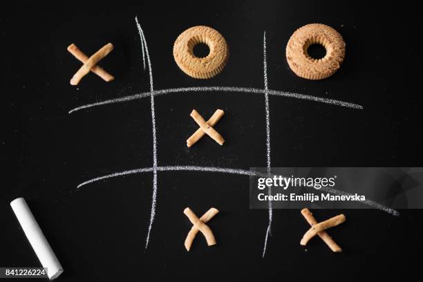 tic tac toe game on blackboard - food game - tic tac toe stock-fotos und bilder