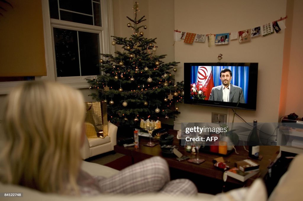 A viewer watches a transmission of Irani