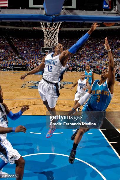 Chris Paul of the New Orleans Hornets shoots as Dwight Howard of the Orlando Magic attempts to block his shot during the game on December 25, 2008 at...