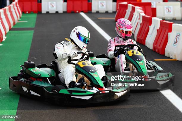 Louis Saha competes with Esteban Ocon of France and Force India in a karting event during previews for the Formula One Grand Prix of Italy at...