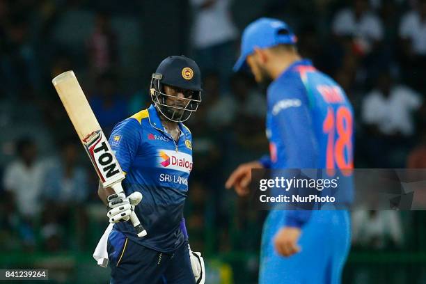 Sri Lankan cricketer Angelo Mathews raises his bat after scoring 50 runs during the 4th One Day International cricket match between Sri Lanka and...