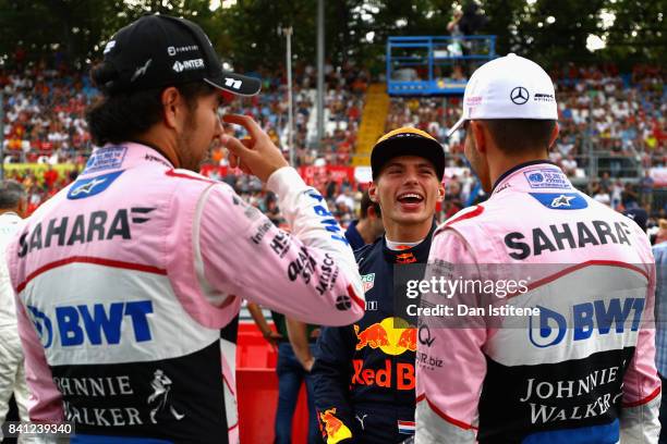 Max Verstappen of Netherlands and Red Bull Racing talks with Esteban Ocon of France and Force India and Sergio Perez of Mexico and Force India at a...