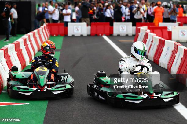 Max Verstappen of Netherlands and Red Bull Racing competes with Dida at a karting event during previews for the Formula One Grand Prix of Italy at...