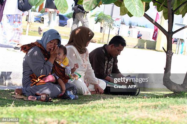 Family pray for their loved ones at the Ulee Lheue port in Banda Aceh on December 26, 2008 killed during the tsunmai in 2004. Indonesia on December...