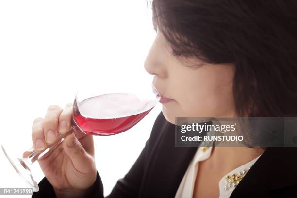 middle-aged woman drinking wine - ミディアムヘア ストックフォトと画像