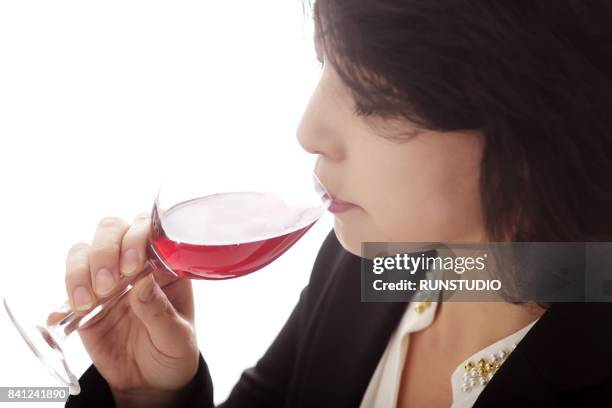 middle-aged woman drinking wine - mid length hair 個照片及圖片檔