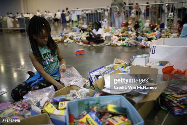 Children from families forced from their homes due to flooding play with donated toys at the NRG Center August 31, 2017 in Houston, Texas. Thousands...